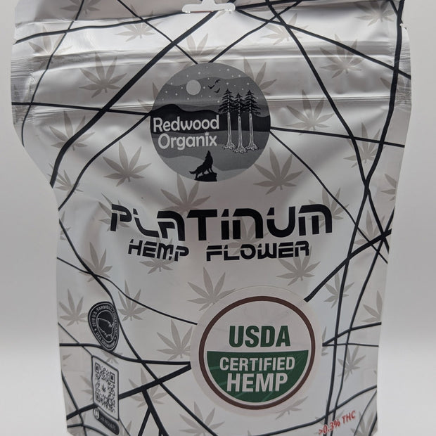Redwood Organix Flower(s) in a white resealable pouch with black geometric lines, leaf motifs, and USDA Certified Hemp label