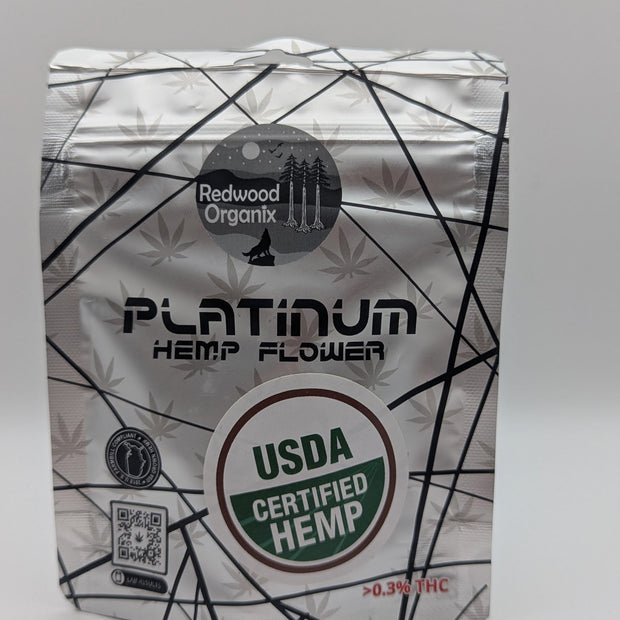 Redwood Organix Flower in a silver-and-white hemp flower pouch with black geometric lines and USDA Certified Hemp seal